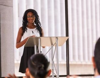 Student gives professional presentation in front of group