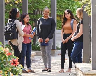 Group of diverse students outside in Reiman Plaza